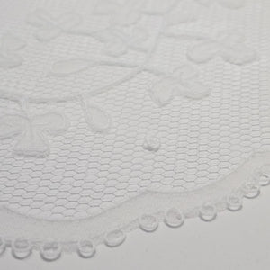 Detail of shamrock pattern handmade Carrickmacross lace