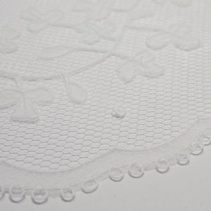 Detail of shamrock pattern handmade Carrickmacross lace