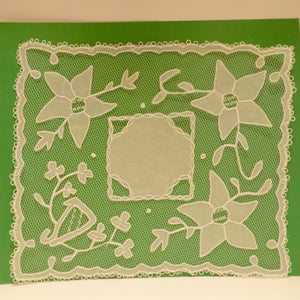 Handmade Carrickmacross lace with flowers and harp.
