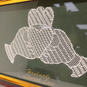 detail of framed Limerick lace Claddagh