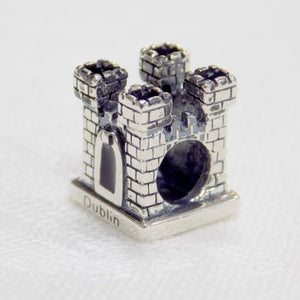 A castle shaped sterling silver bead charm